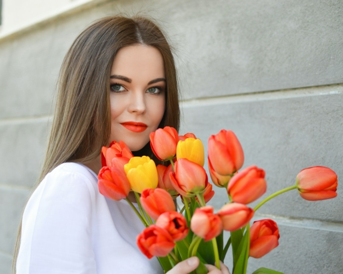 woman with bouquet of pink and yellow tulips