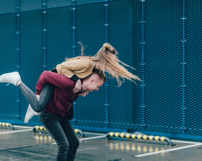 man carrying woman on back