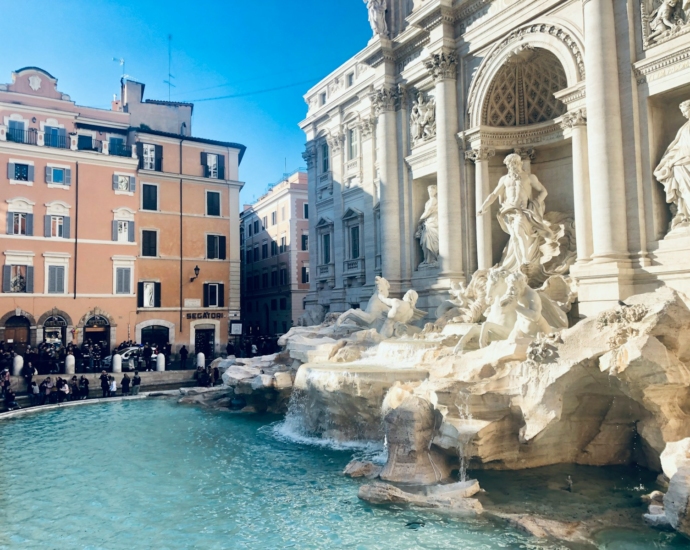 a group of people standing around a fountain