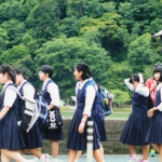 group of women in school uniform standing on green grass field during daytime