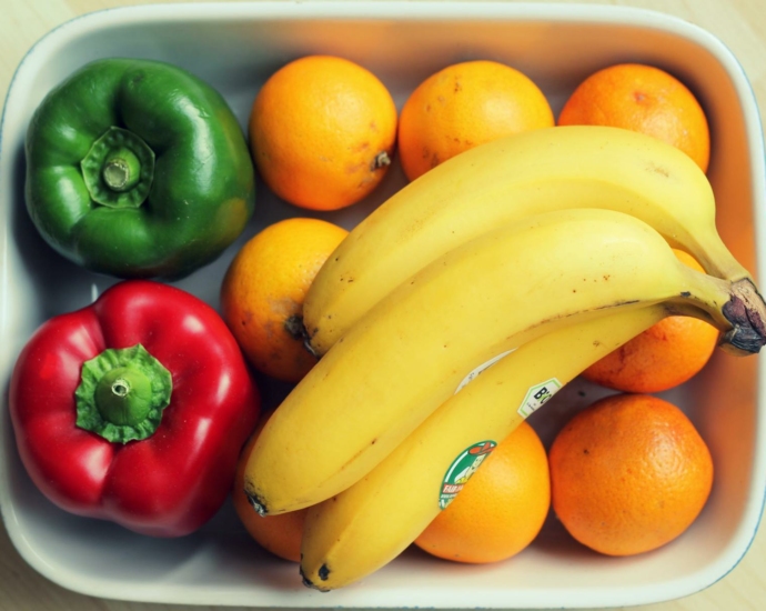 Top View Photography of Yellow Bananas and Two Peppers