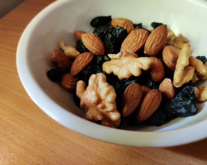 brown and black nuts on white ceramic bowl