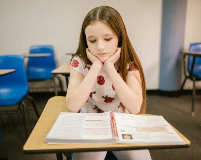 Girl Sitting on Her Desk Looking Lonely