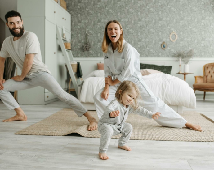 A Couple Stretching Their Legs while Looking at Their Cute Daughter