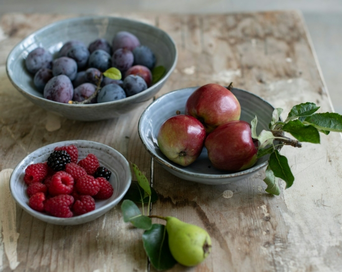 red and green apples on white ceramic bowl