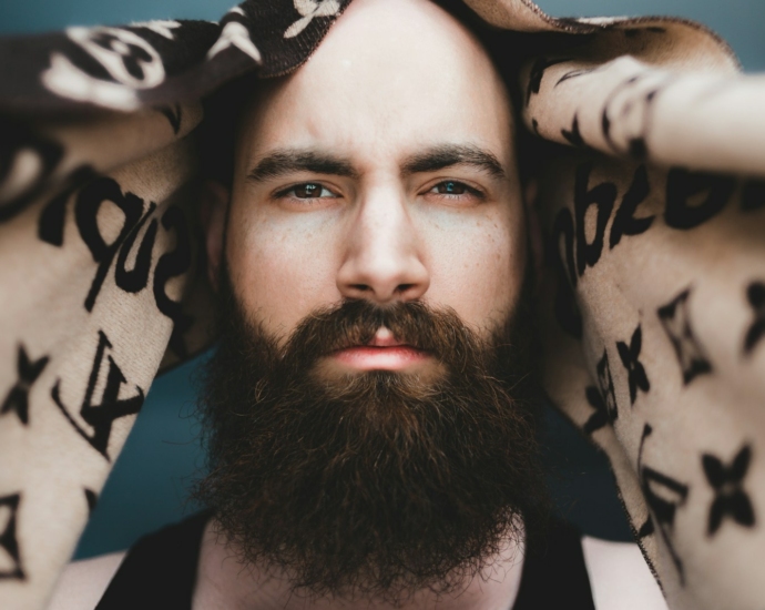 man in black tank top lying on white and black textile