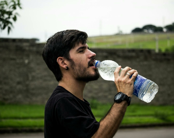 Man Wearing Black Shirt Drinking Water