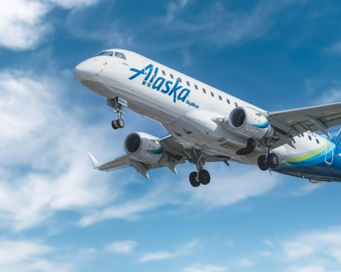 white and blue passenger plane under blue sky during daytime