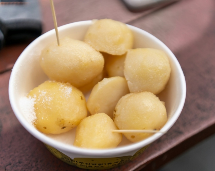 a white bowl filled with food on top of a wooden table