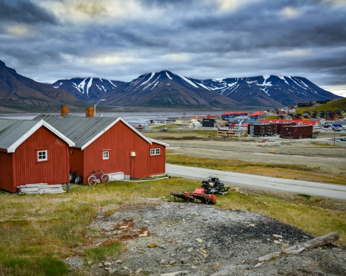 red and white barn near mountain under white clouds during daytime