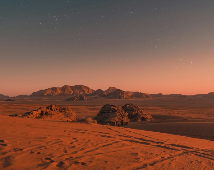 brown sand under blue sky during night time