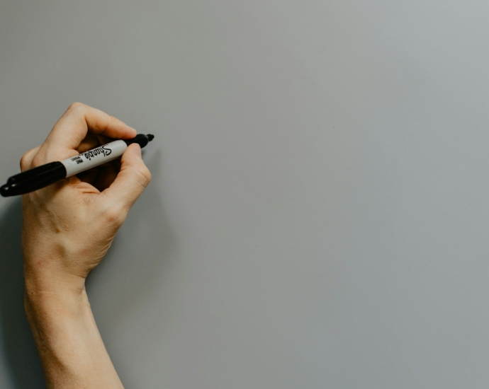 person holding black and white pen