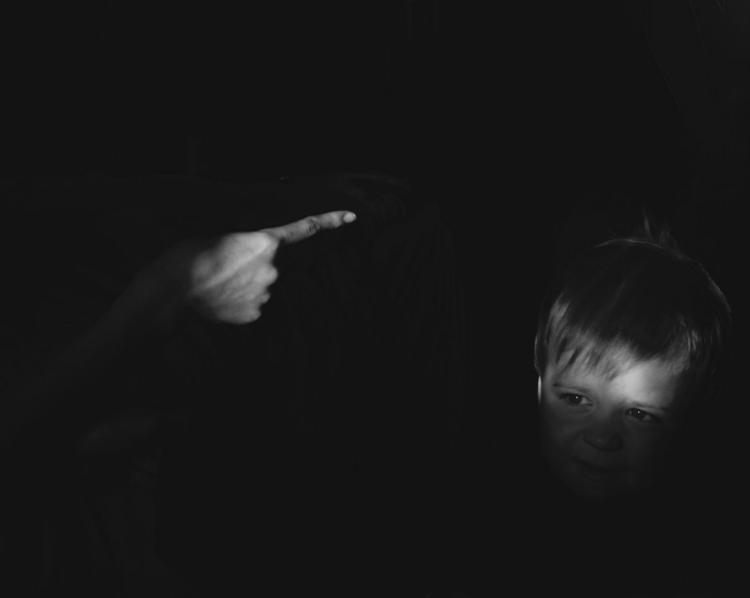 grayscale photo of girl holding her chin