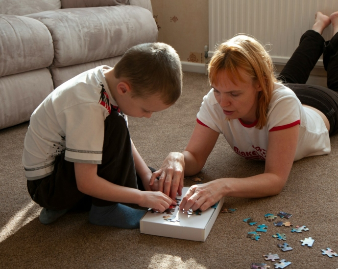 a boy and girl playing with a toy