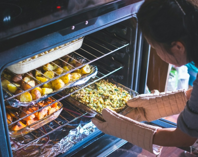 woman put food on oven