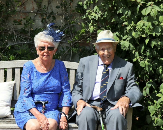 Woman Sitting Beside Man On WOoden Bench