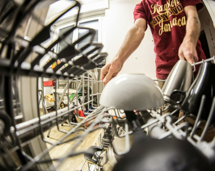 Fish-eye Photography of Man Pulling the Dishwasher Rack