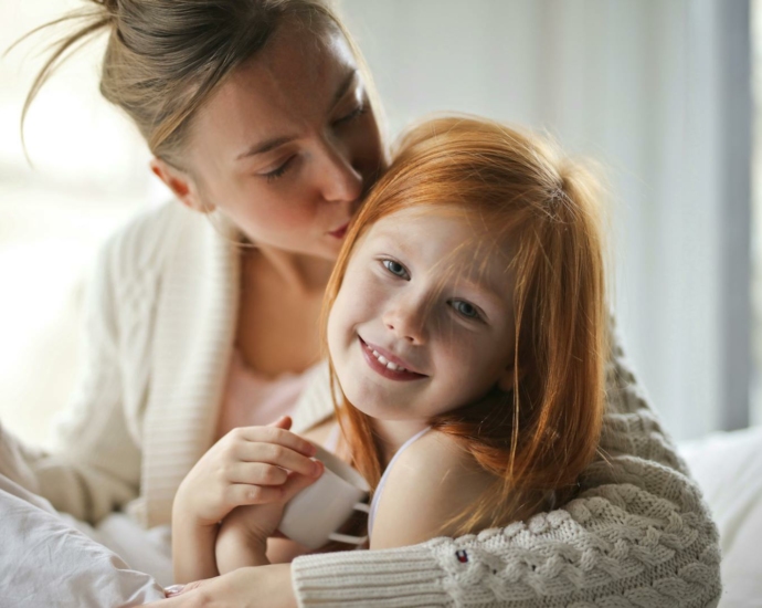 A mother Kissing Her Child