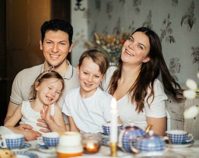 Loving family laughing at table having cozy meal