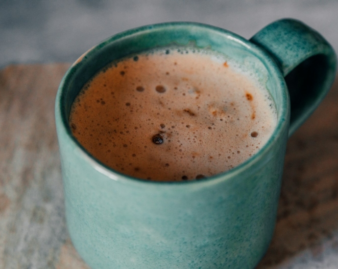 white ceramic mug with brown liquid