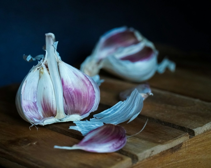 white and purple flower petals on brown wooden table