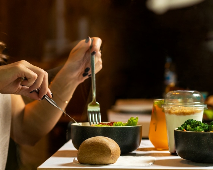 person holding silver fork and knife