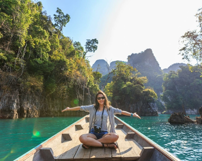 Photo of Woman Sitting on Boat Spreading Her Arms