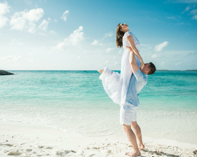 Man in Blue Shirt Carrying Woman in White Dress