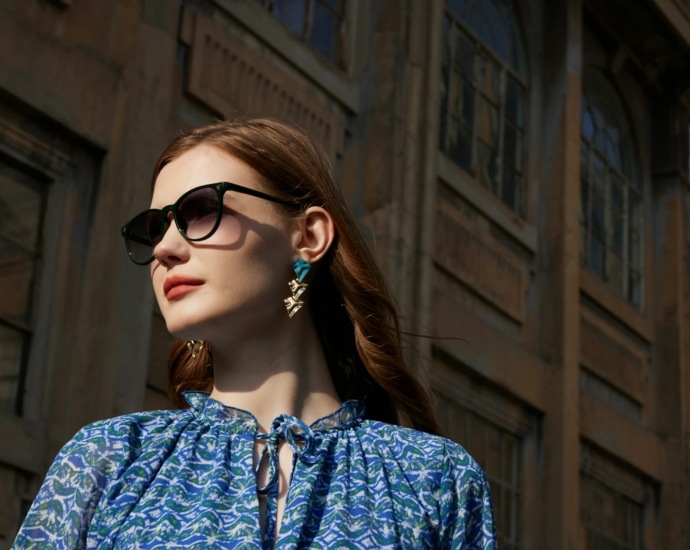 a woman wearing sunglasses and a blue shirt