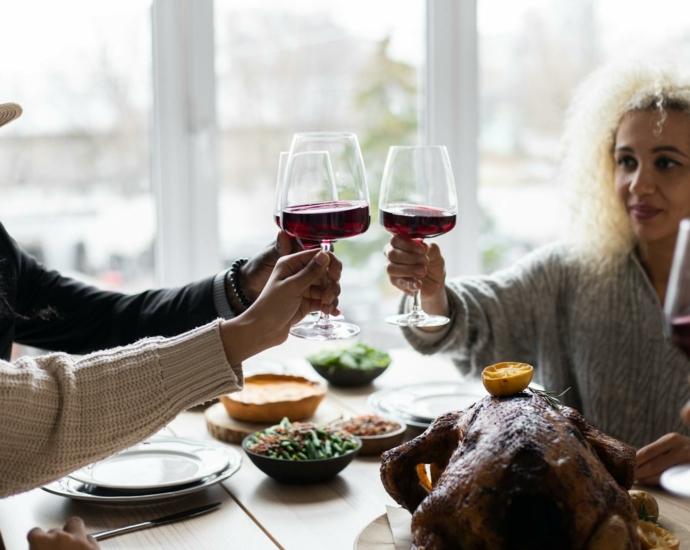 Multiethnic people clinking glasses having dinner