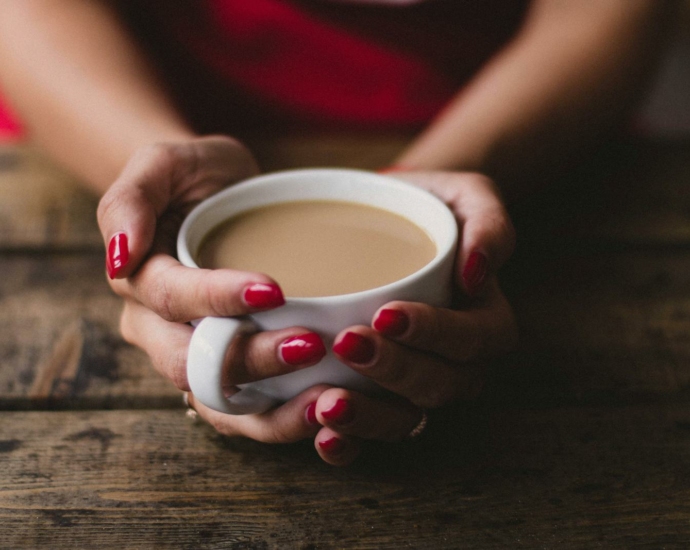 Women Holding Cup Of Coffee