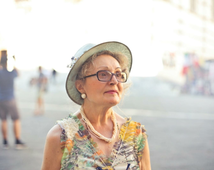 Depth of Field Photography of Woman in Pastel Color Sleeveless Shirt and White Sunhat