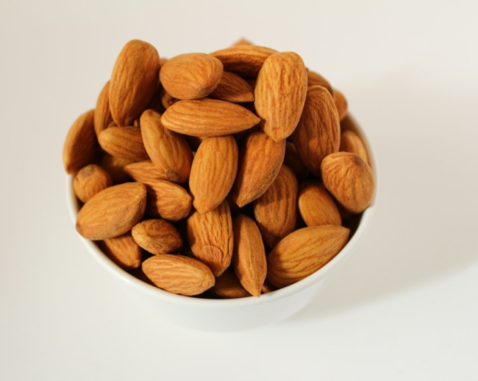 brown almond nuts on white ceramic bowl