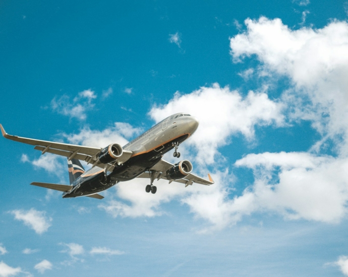 white airplane under blue sky during daytime