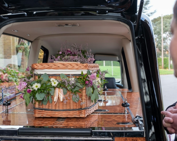 the back of a van with flowers in the trunk