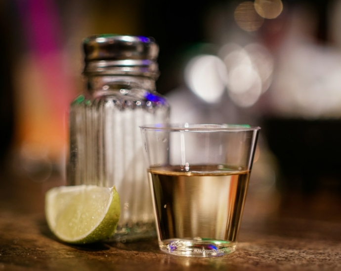 clear glass cup beside sliced lime on brown surface