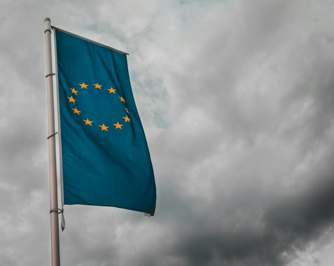 teal flag under cloudy sky