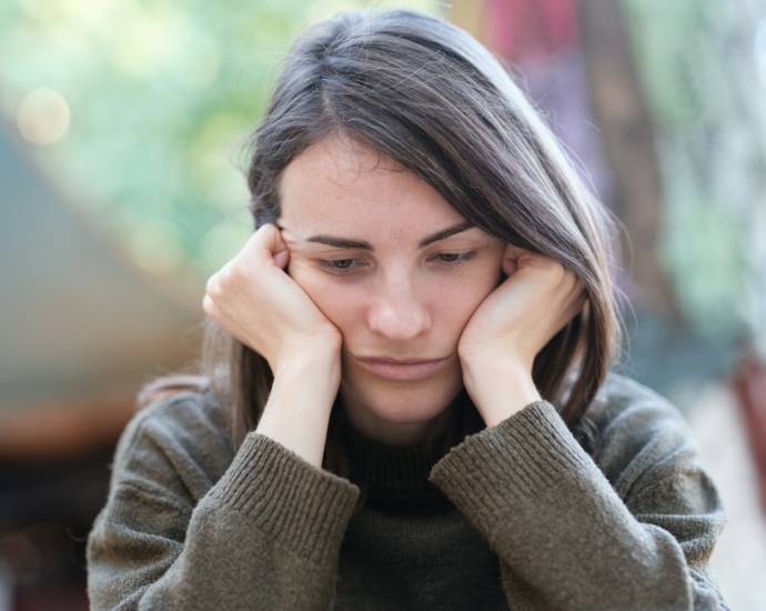 a woman holding her head in her hands