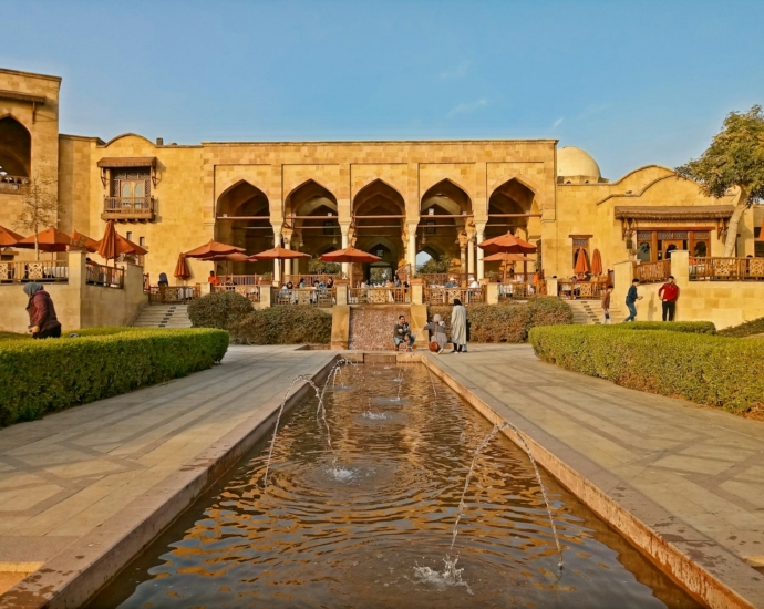 a large building with a fountain in front of it