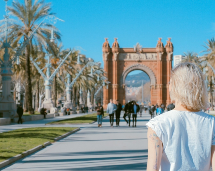 woman standing on road near concrete arch at daytime