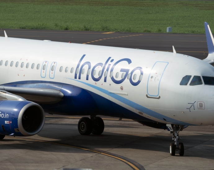 white and blue airplane on airport during daytime