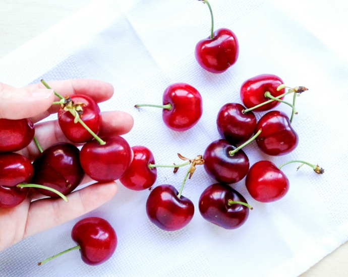 red cherries on white textile