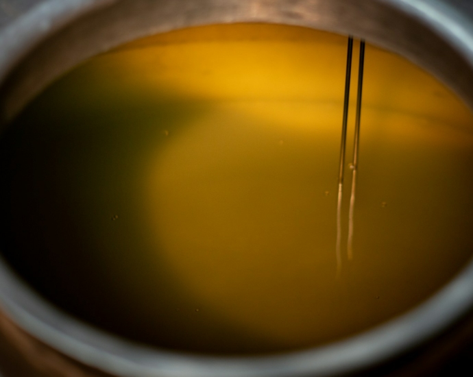 a close up of a cup of liquid with a straw sticking out of it