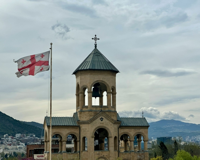 an old building with a flag flying in front of it