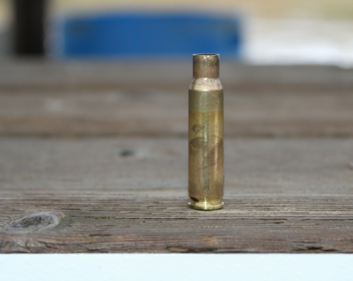 a close up of a bullet on a wooden surface