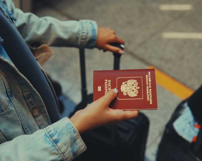 a person holding a red passport in their hand