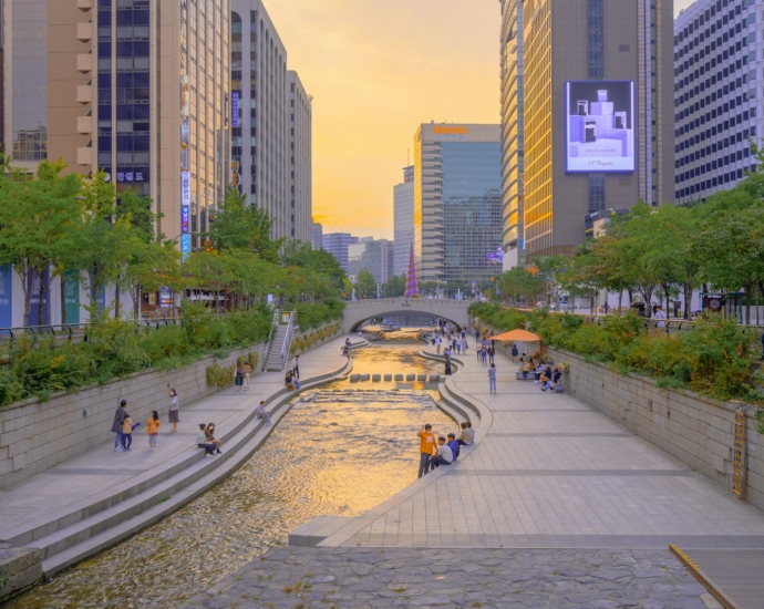 people walking on sidewalk near high rise buildings during daytime