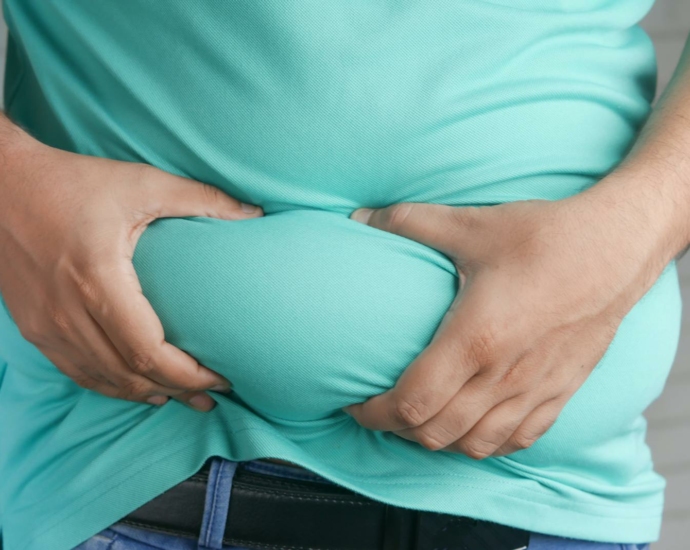 A Person Holding his Belly Fat