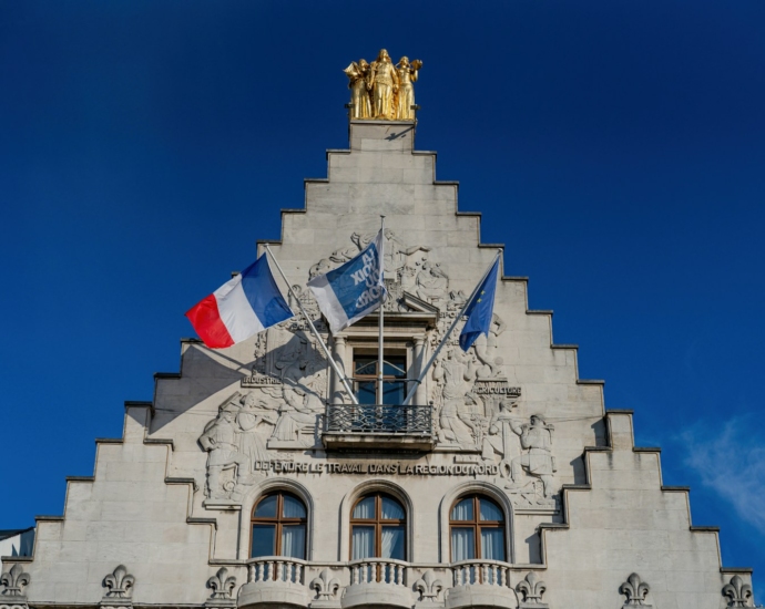 A tall building with a flag on top of it