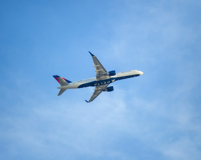 white and red airplane in the sky